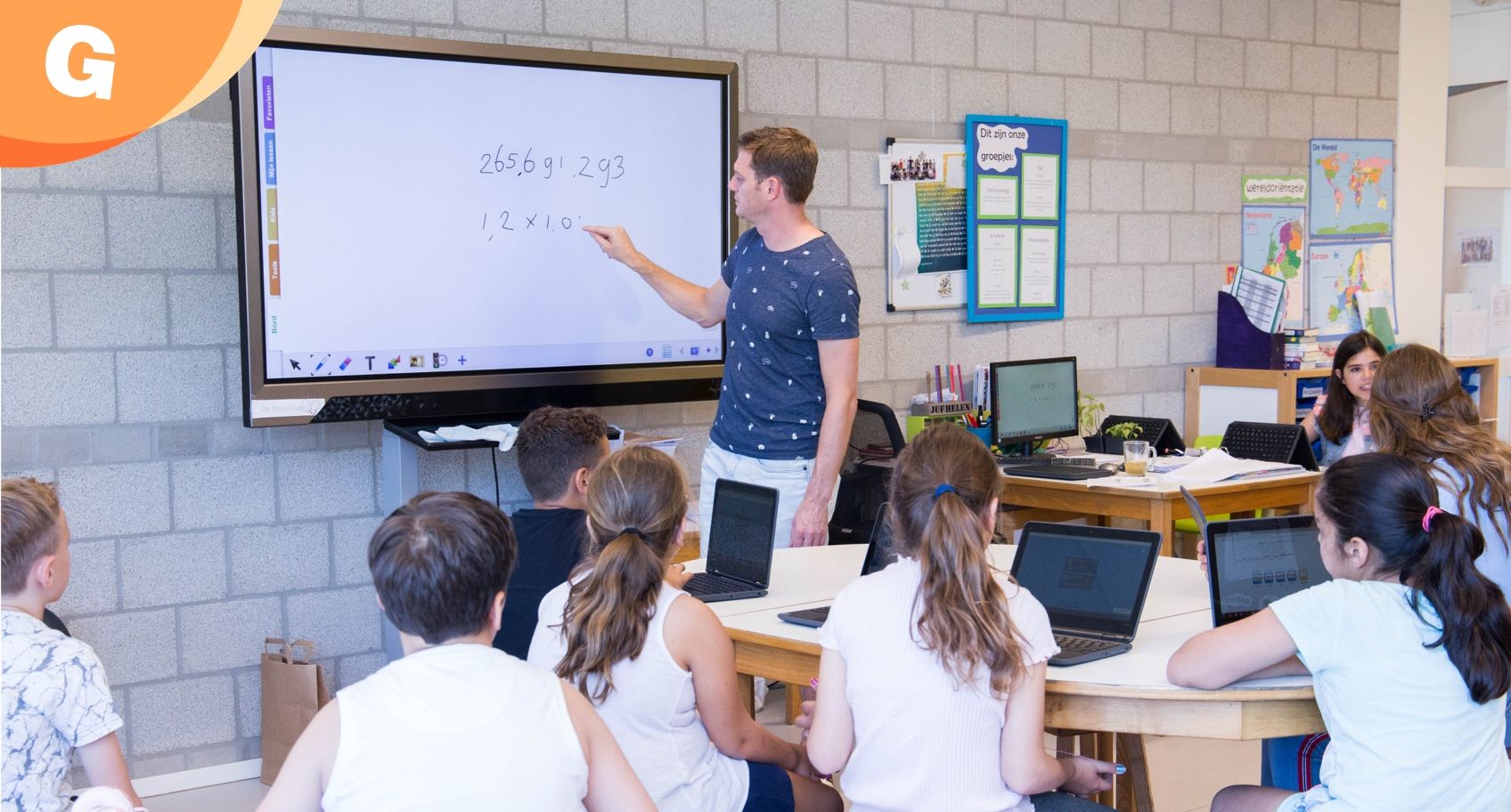 teacher writing on digital whiteboard