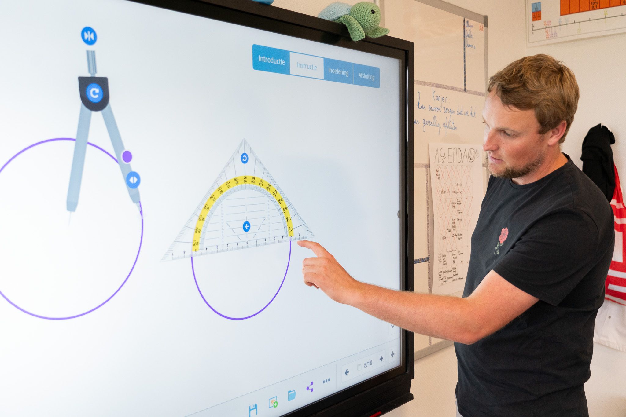 teacher using digital tools on classroom touchscreen